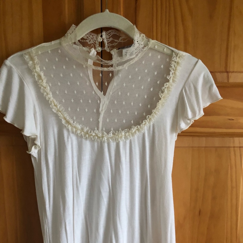 Blouse, ivory in color, bottom ruffle with side ribbon tie